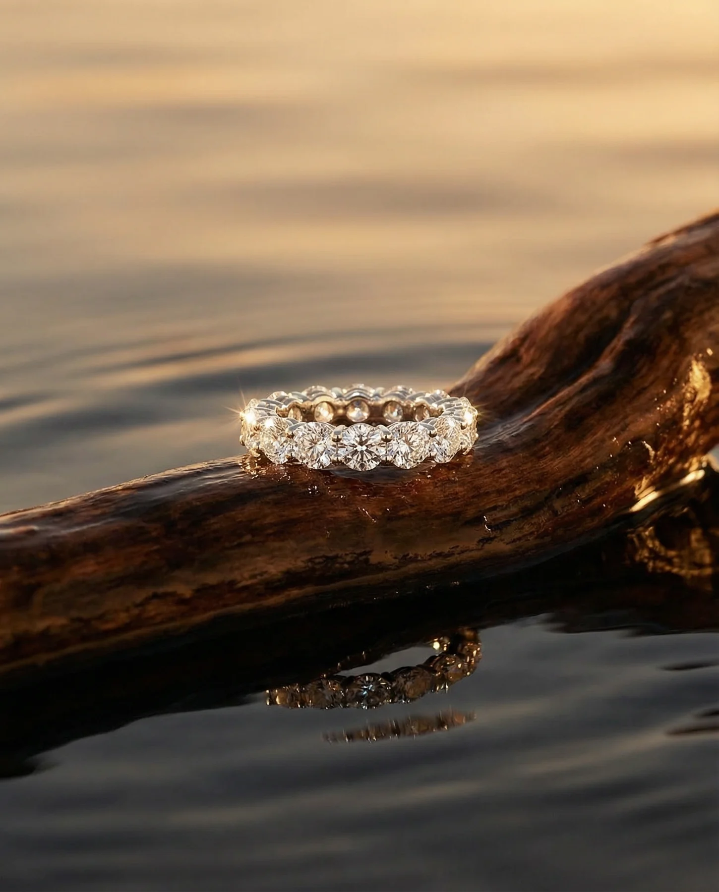 Diamond eternity band resting on polished wood by water